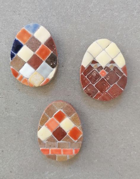 Three D-shaped mosaic decorations