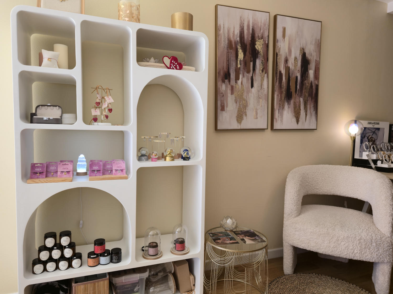 A white arched storage unit filled with beauty products, decorations, and