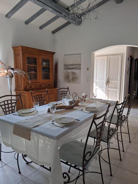 Living room, white dining room with wrought iron table and chairs