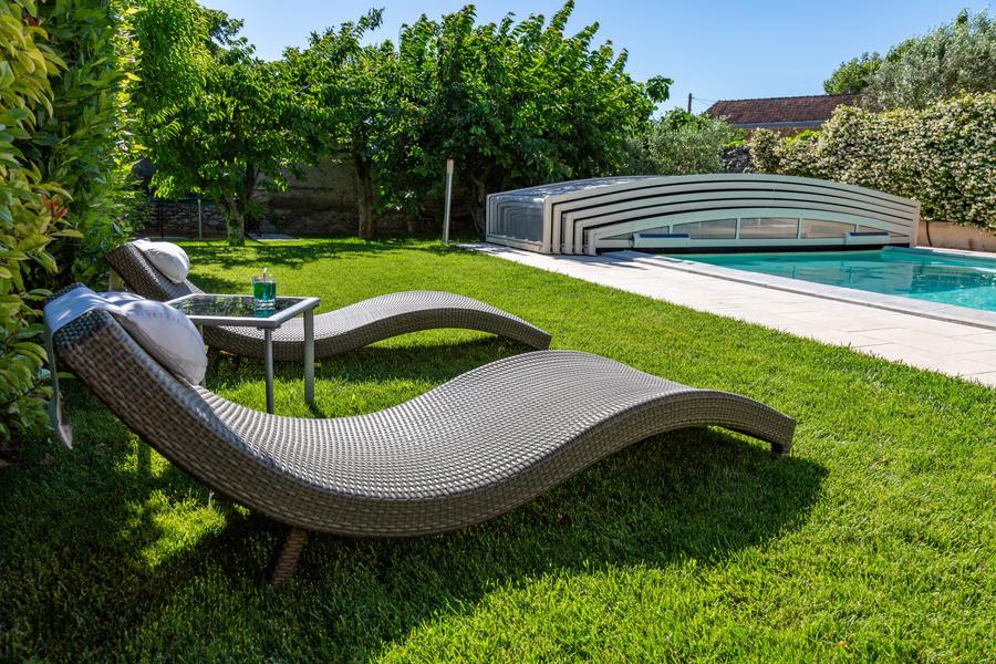 Gray sunbathing woven on grass by the indoor pool.