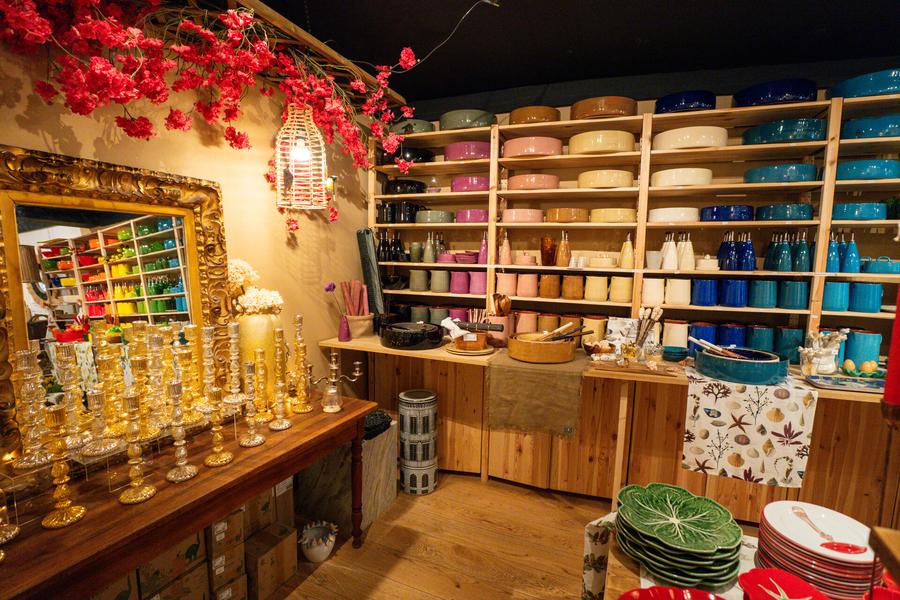 Interior of the shop: plates of various colors, candlesticks...