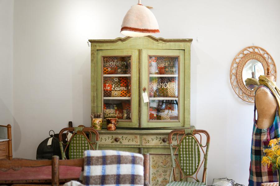 Antique green mottled furniture with rattan chairs in front