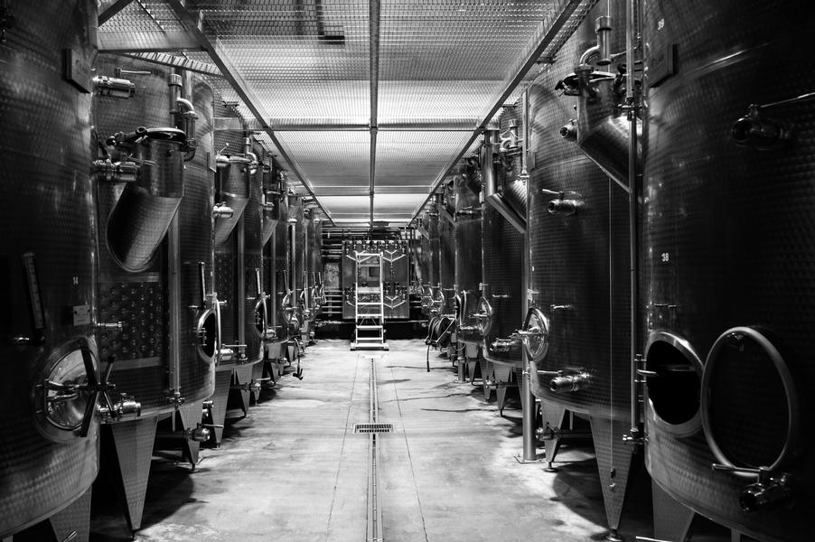 black and white photo - stainless steel barrel aisle