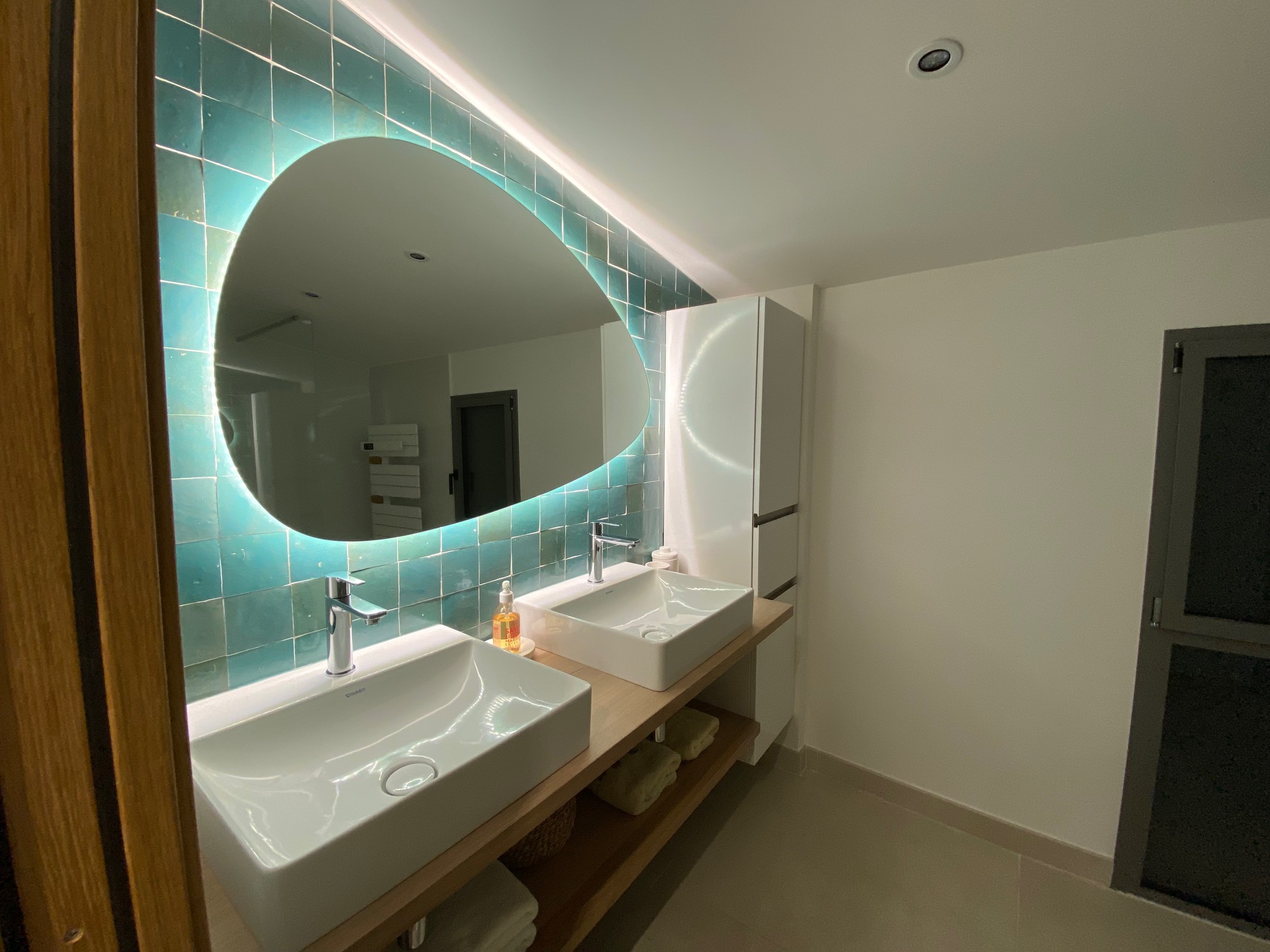 Bathroom with double sink and oval mirror 