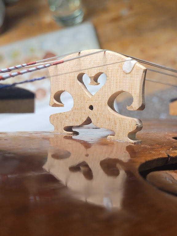 Close-up on a violin bridge freshly cut and adjusted by hand in Lucas Gauthier-Lurty