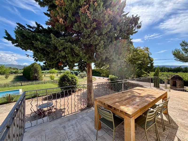 Large terrace with unobstructed views of the garden and the Provençal countryside, perfect for outdoor dining and relaxing moments.