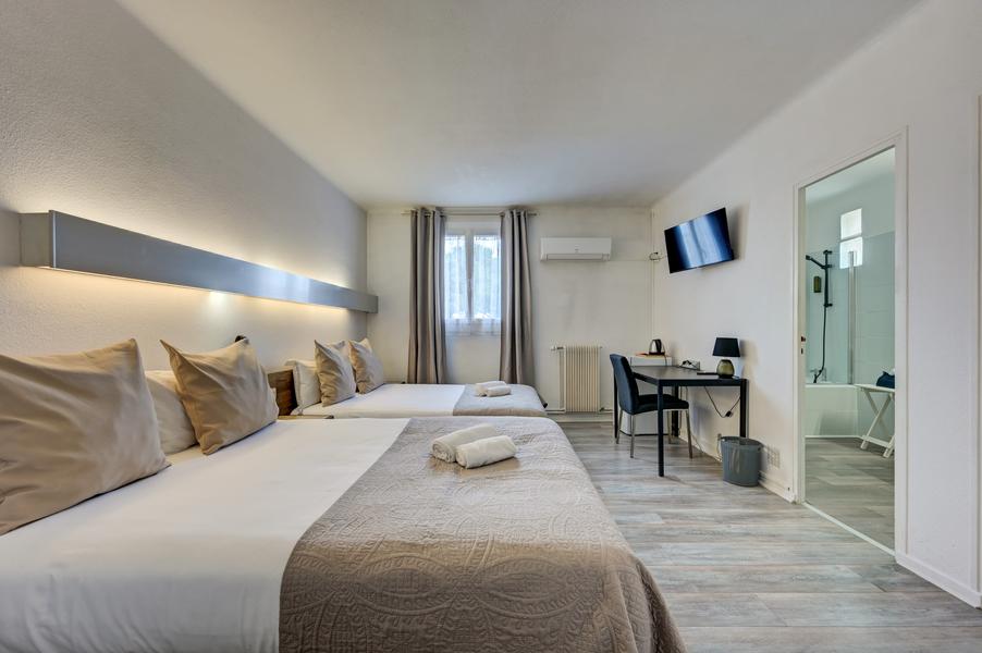 This spacious and air-conditioned family room has several comfortable beds, ideal for a stay with family or friends near L
