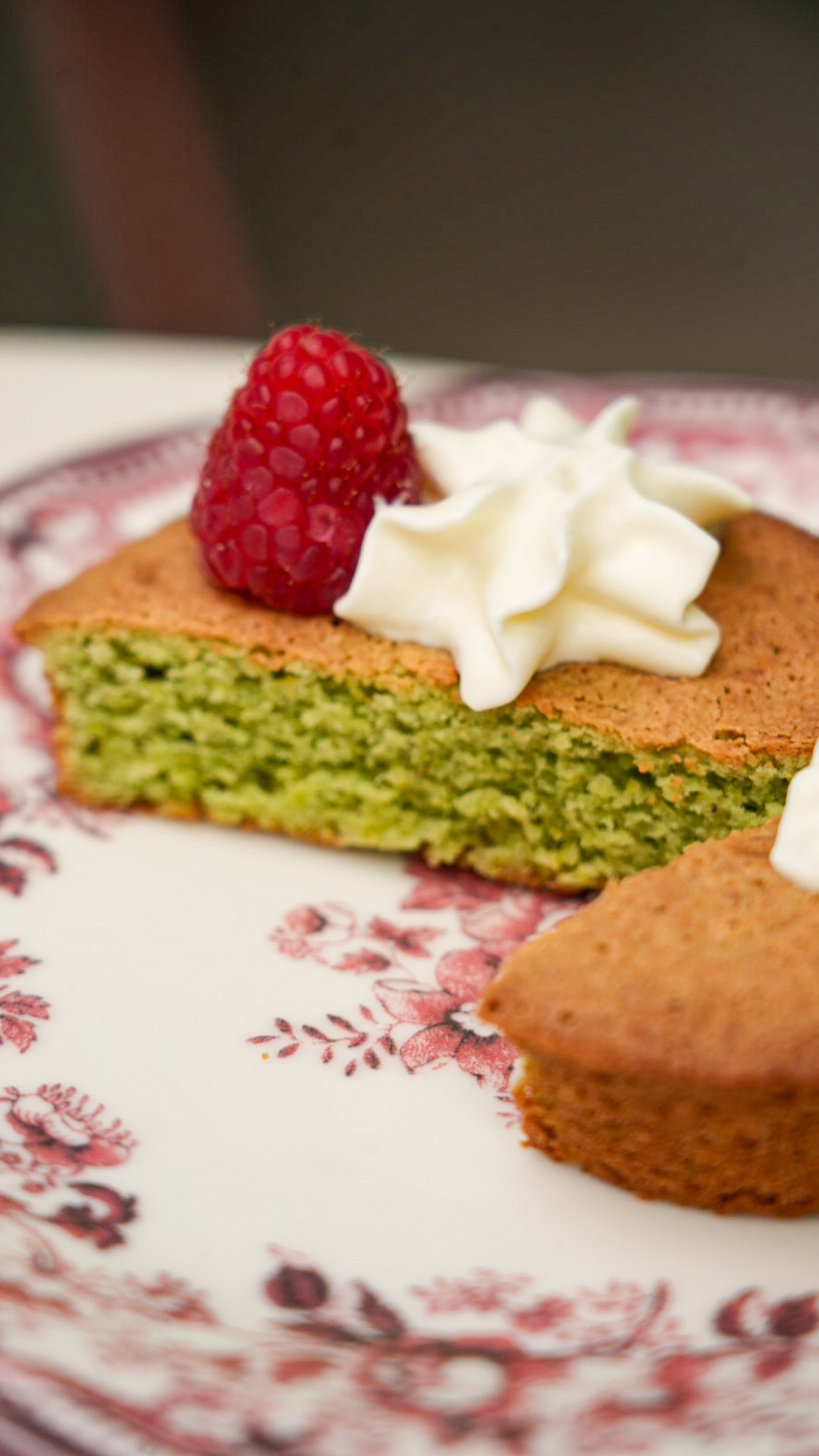 A slice of soft matcha tea cake reveals a tender crumb of